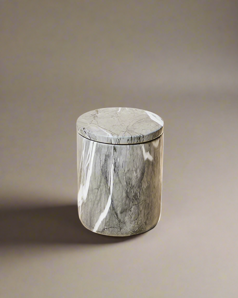 Closed luxury candle in a polished dark gray marble vessel with white veining, featuring a sleek, minimalist design.
