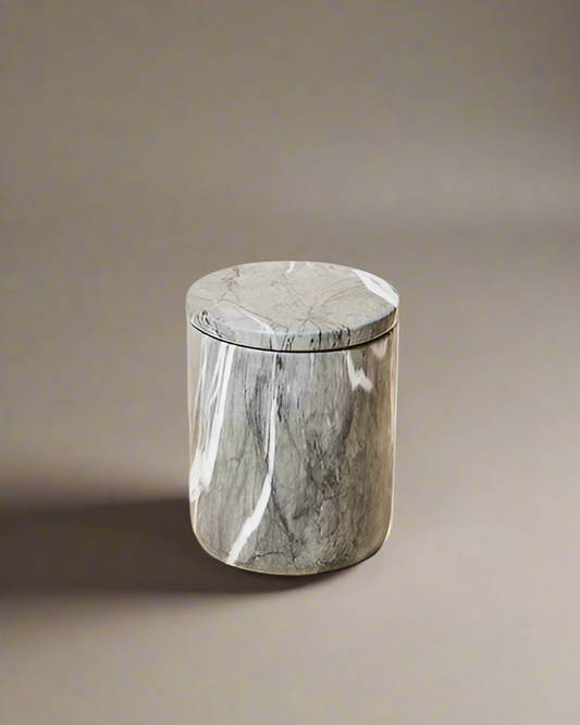 Closed luxury candle in a polished dark gray marble vessel with white veining, featuring a sleek, minimalist design.