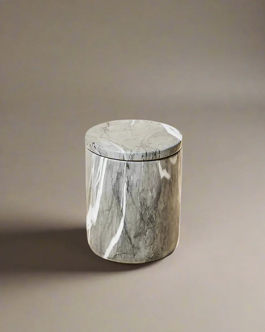 Closed luxury candle in a polished dark gray marble vessel with white veining, featuring a sleek, minimalist design.