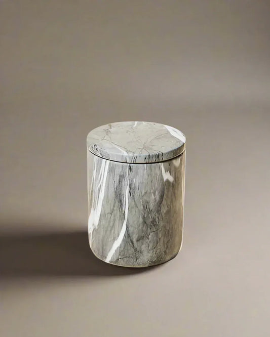 Closed luxury candle in a polished dark gray marble vessel with white veining, featuring a sleek, minimalist design.