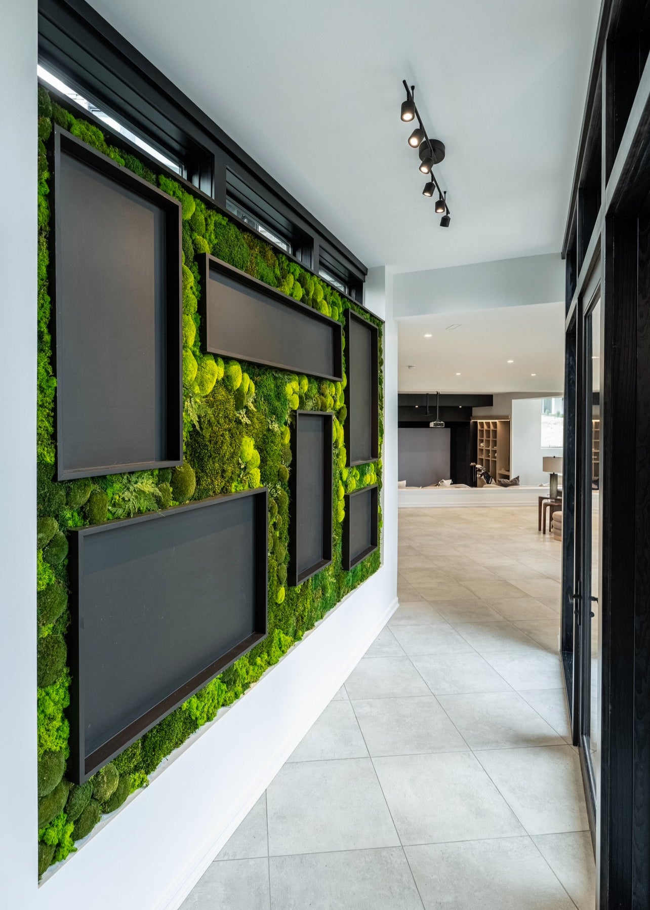 A lush green preserved moss wall featuring ball moss, mood moss, cushion moss, reindeer moss, and other types of preserved mosses, greenery, and ferns installed by Hunter Frescoln, owner of Trendy Gardener, in one of the 2025 custom home show homes.