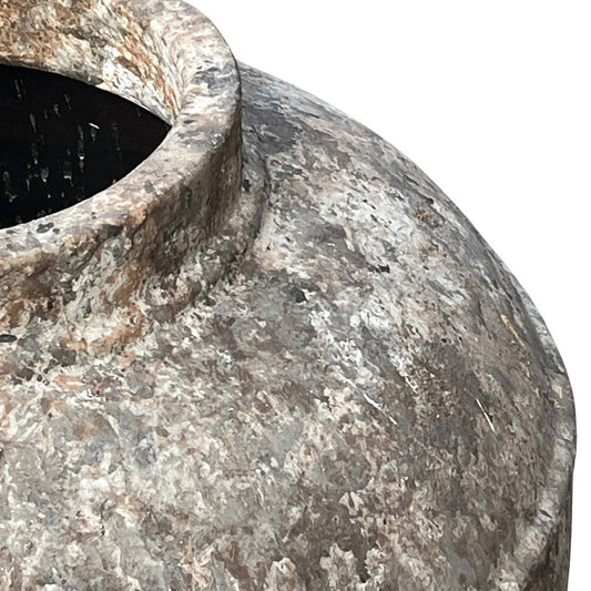 Close-up detail of handmade Indonesian terracotta planter showing natural clay texture and craftsmanship.