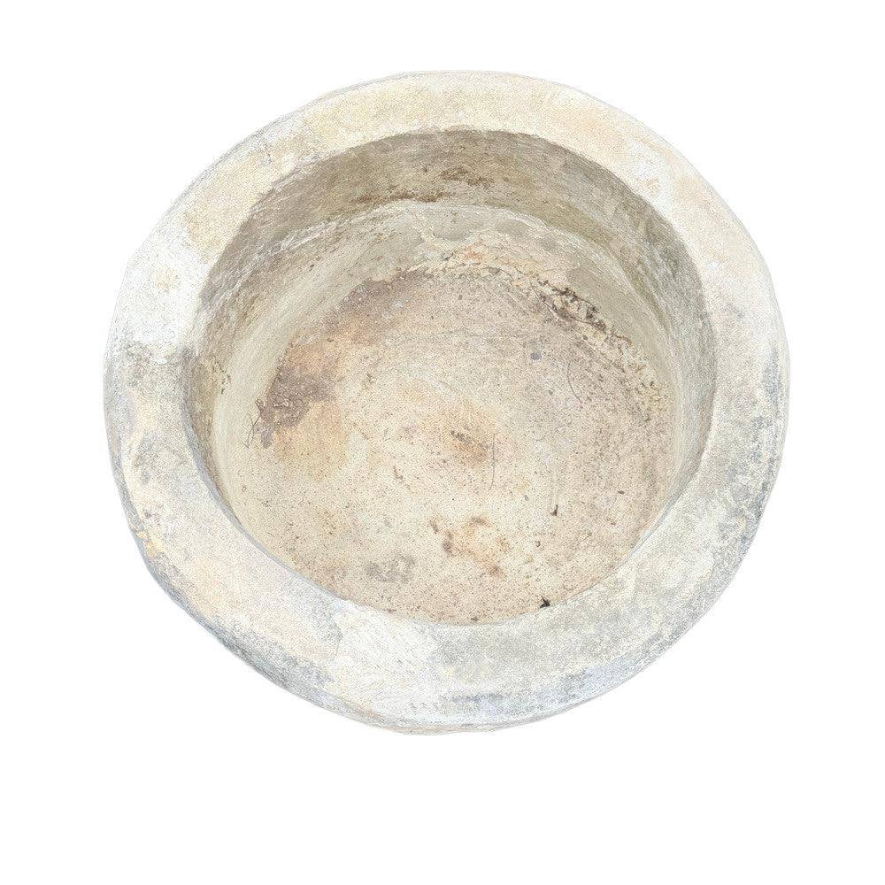 Antique Indonesian limestone trough planter styled in refined interior, 29.5"W × 24.5"H with sculptural plant arrangement.