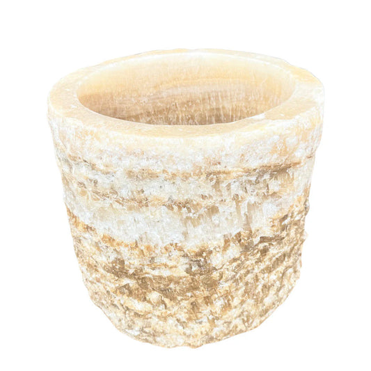 Onyx stone planter shown from an angled view with textured exterior detail