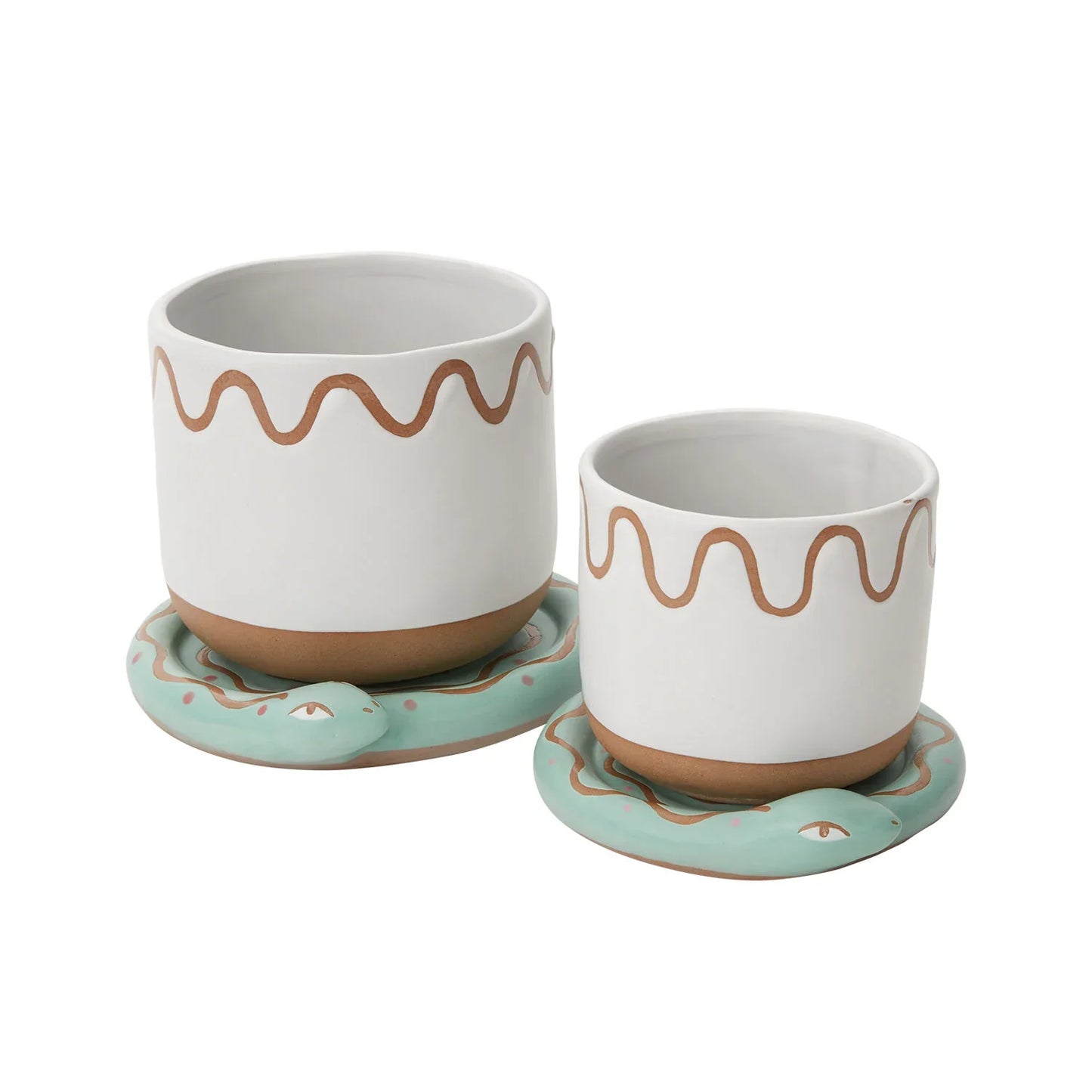 A whimsical ceramic plant pot with an earthy white and brown design, paired with a coiled green snake-shaped tray.