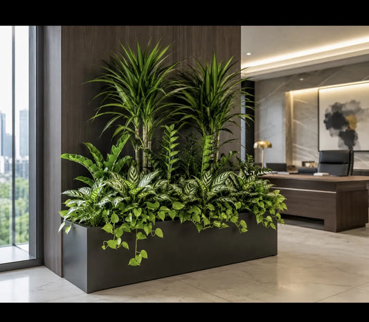 Indoor planter with lush greenery in a modern office setting.