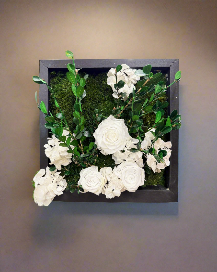 Features preserved boxwood, mood moss, white preserved roses, and hydrangeas -all maintenance-free and made with love by Trendy Gardener.
