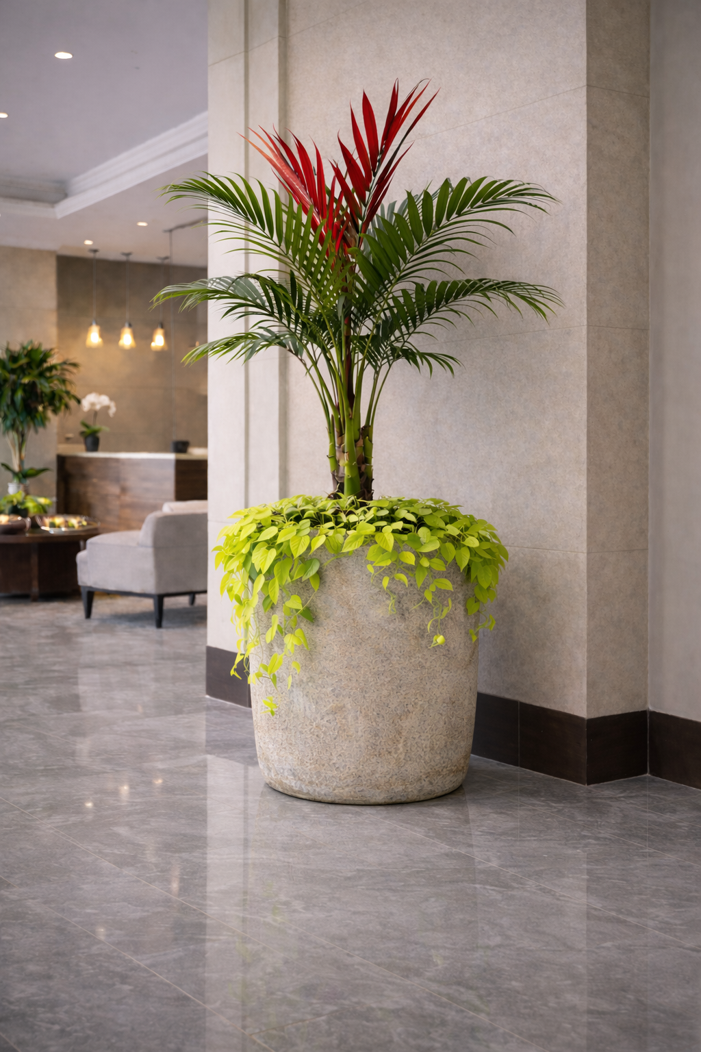 Refined corporate lobby downtown Des Moines with tall sculptural plants, oversized vessels, and layered greenery that soften hard surfaces and create a welcoming first impression for guests and teams.