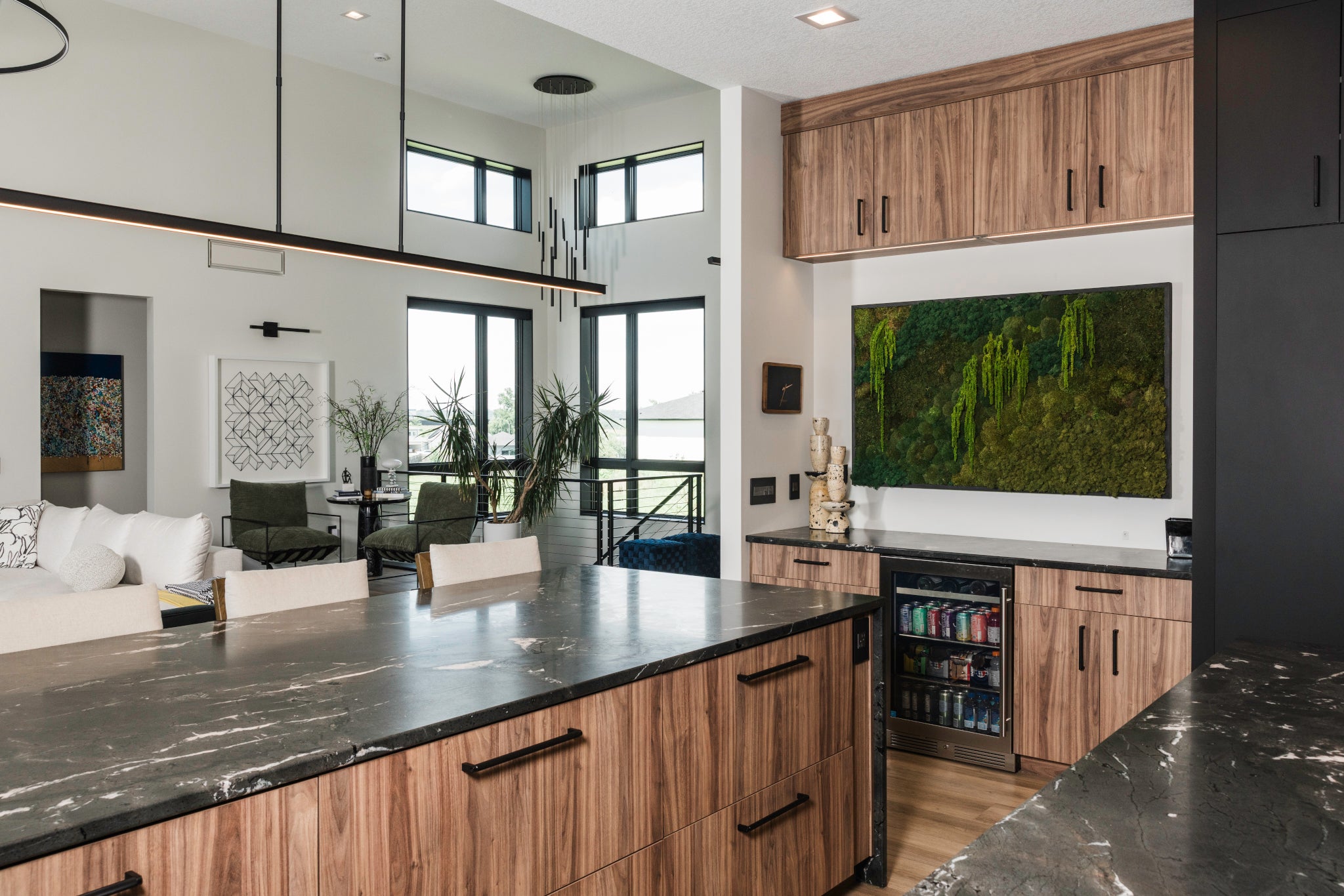 Modern kitchen with wooden cabinets, marble countertops, and a custom preserved moss wall featuring green mood moss, lichen, rock moss, ball moss, pole moss, cushion moss, cloud moss, residential moss wall art, custom residential moss wall, Trendy Gardener.