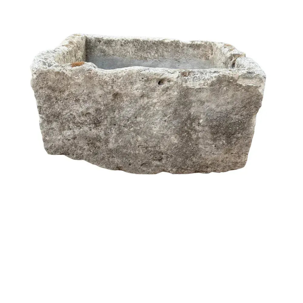 Limestone vessel detail showing natural surface variation and carved form