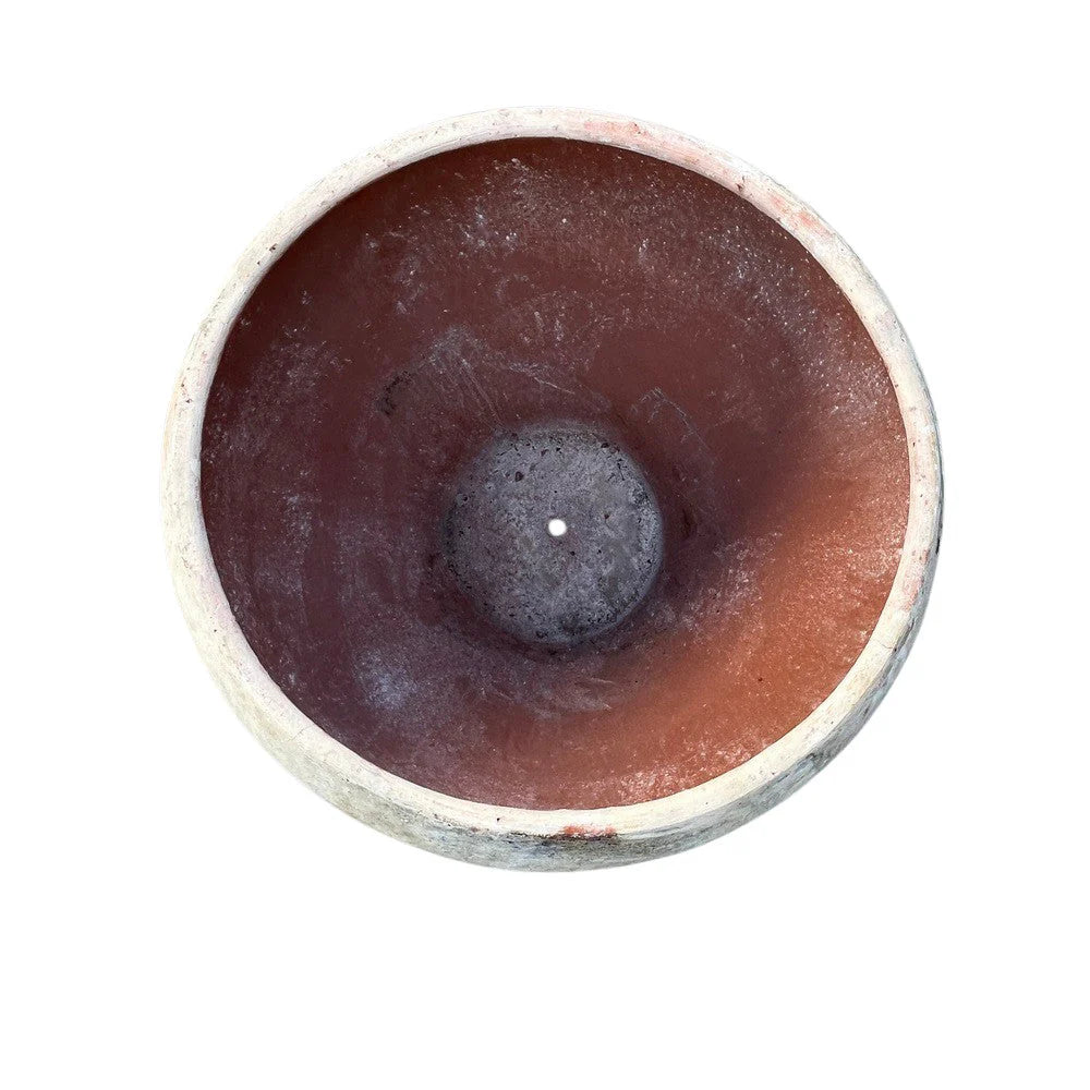 Large round planter used outdoors on a terrace or courtyard