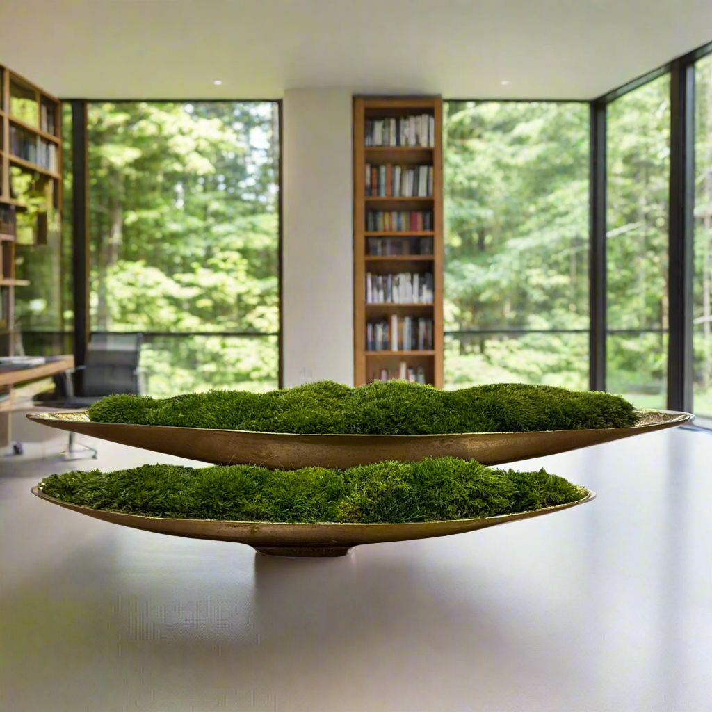 Large and Extra Large Moss Centerpieces in Gold Boats resting on a table overlooking a modern living room.