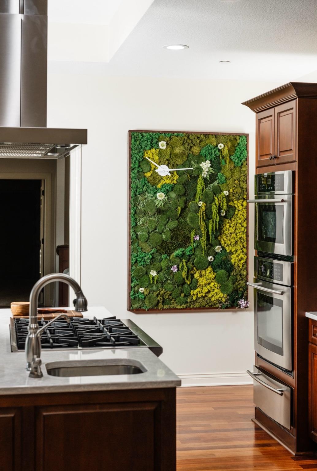 A curated biophilic masterpiece, integrating sustainably preserved moss and cascading greenery for a modern yet organic aesthetic. West Des Moines, Iowa.