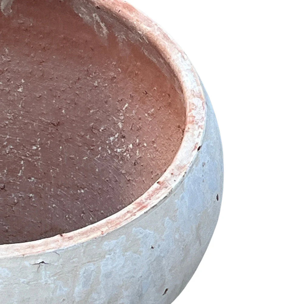Close-up of a ceramic pot with a textured interior and smooth exterior.