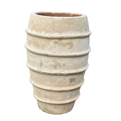 Ribbed terracotta planter with distressed finish, sculptural vertical texture