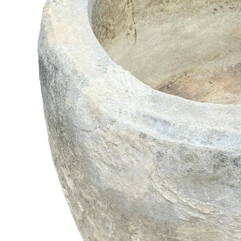 Close-up of antique limestone trough from Indonesia, showcasing hand-carved surface detail and aged patina.