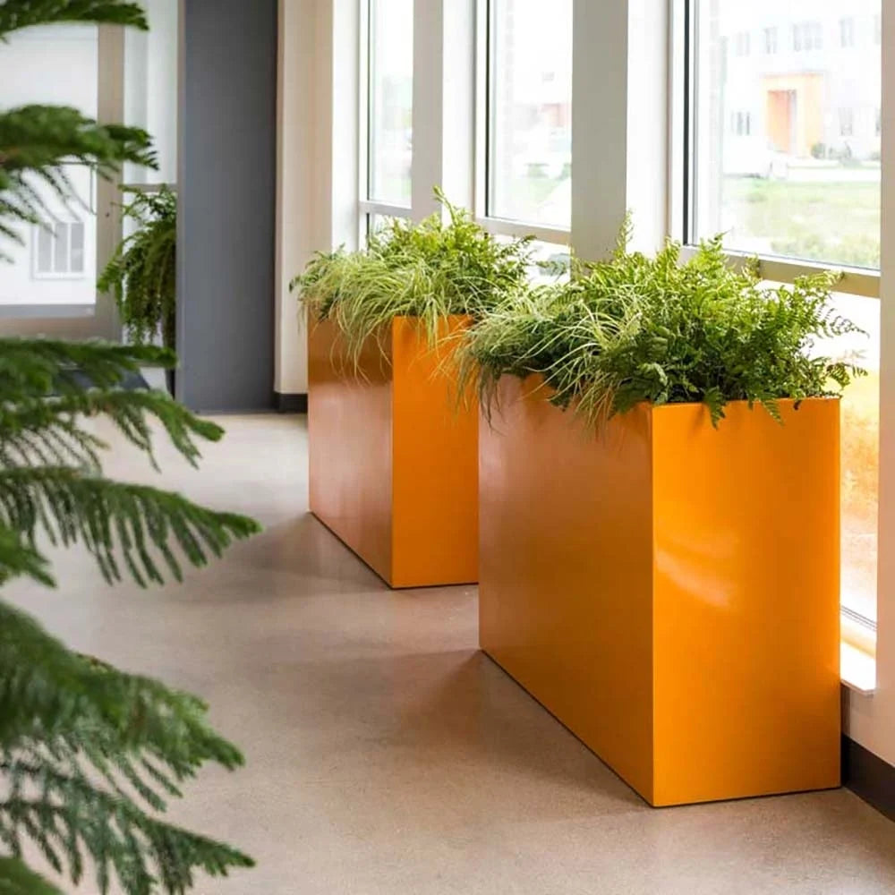 A sleek fiberglass rectangle planter in a bright orange finish, featuring a modern rectangular design, perfect for indoor and outdoor plantscaping in residential and commercial spaces.