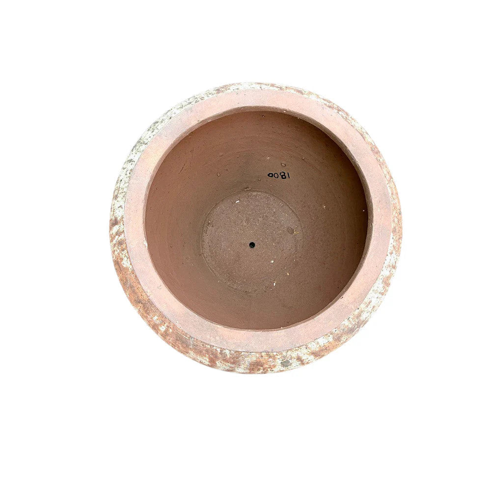 Large round terracotta planter displayed as an entryway statement piece