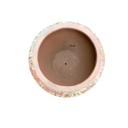 Large round terracotta planter displayed as an entryway statement piece