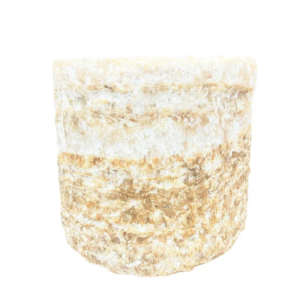 Handcrafted onyx planter with a sculptural round form and natural stone character