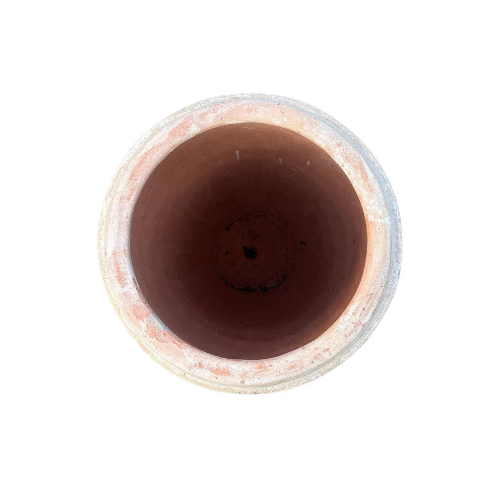 Close-up of vertical ribbing and timeworn patina on terracotta surface