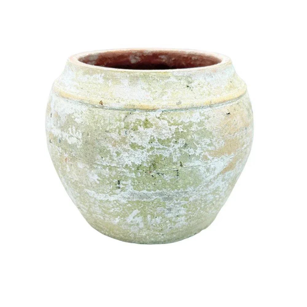 Decorative Vietnamese terracotta vessel styled on a shelf with collected accents