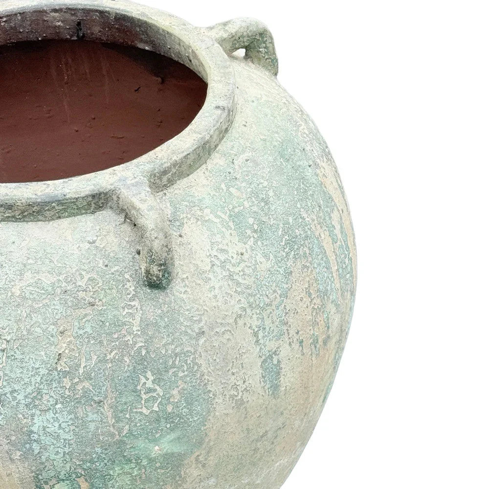 Close-up of the texture and handle detail on a terracotta planter